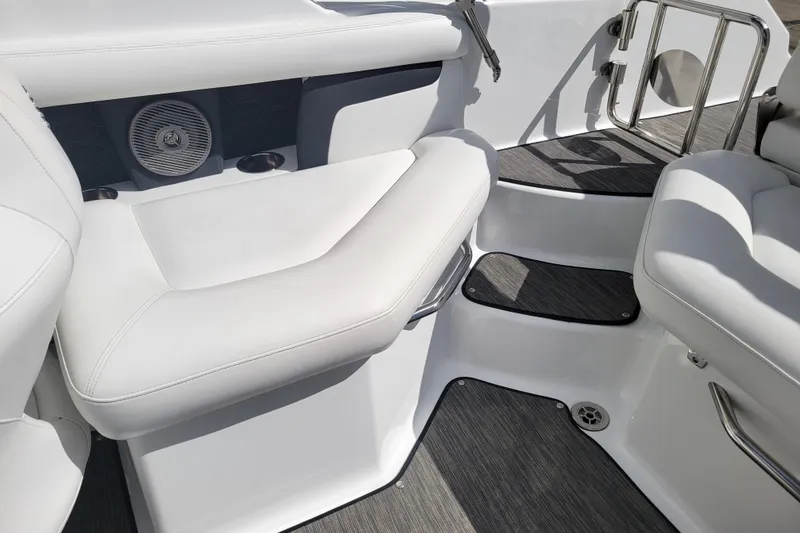 Slide: The Image of 2022 Four Winns HD3 boat interior with white seating and speaker detail. - 15