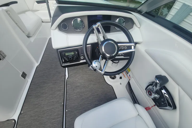 Slide: The Image of 2022 Four Winns HD3 boat interior with steering wheel and control panel. - 20