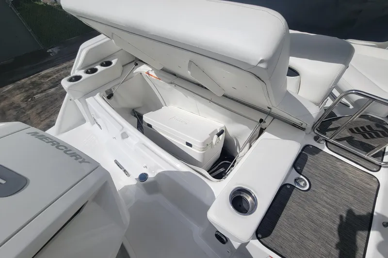 Slide: The Image of 2022 Four Winns HD3 boat interior with storage compartment and cooler. - 24