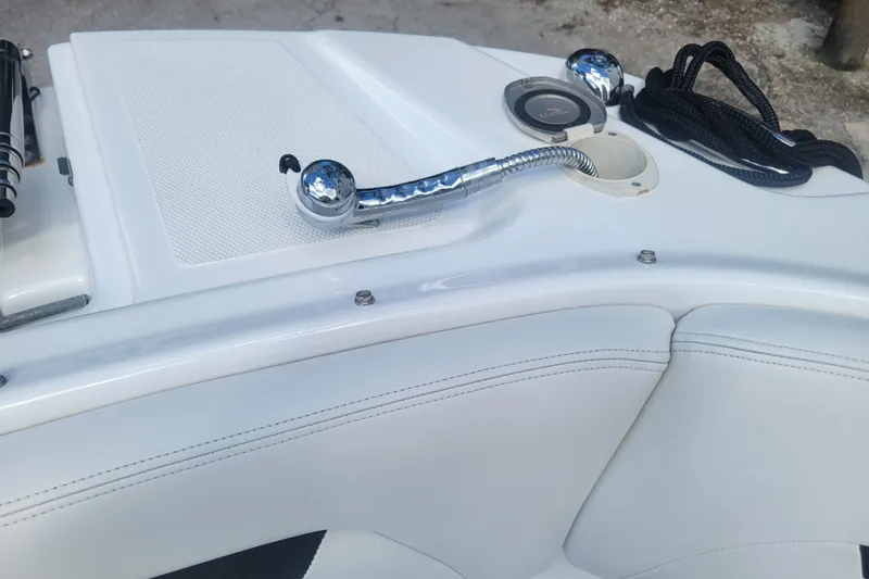 Slide: The Image of 2022 Four Winns HD3 boat interior with chrome fixtures and white upholstery. - 36