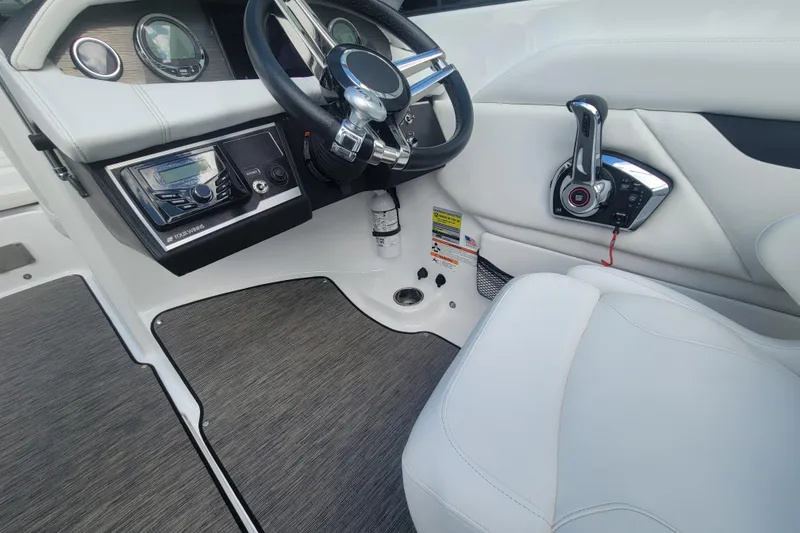 Slide: The Image of 2022 Four Winns HD3 boat interior with steering wheel and control panel. - 18