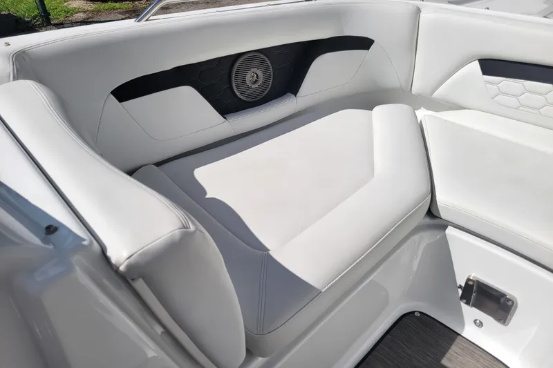 Slide: The Image of 2022 Four Winns HD3 boat interior with white cushioned seating and speaker detail. - 34
