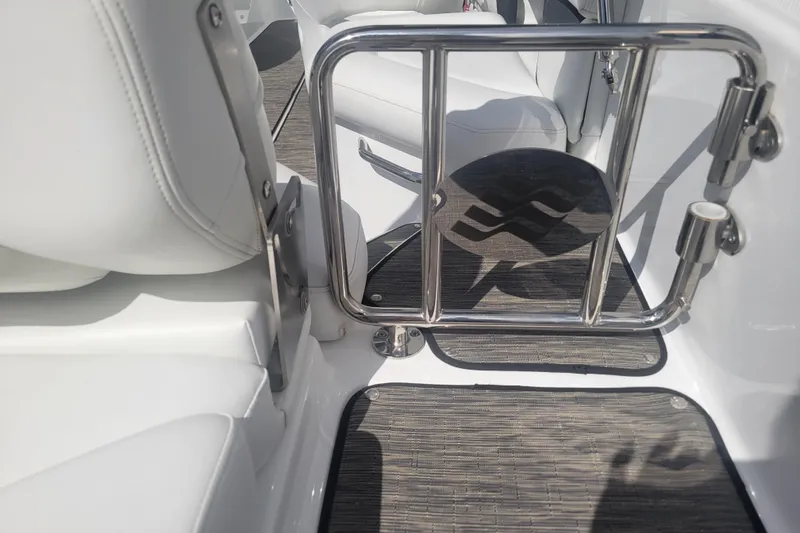Slide: The Image of 2022 Four Winns HD3 boat interior with stainless steel gate and white seating. - 11