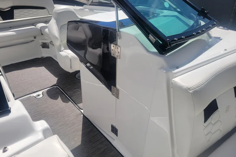 Slide: The Image of 2022 Four Winns HD3 boat interior with white seating and sleek design. - 29