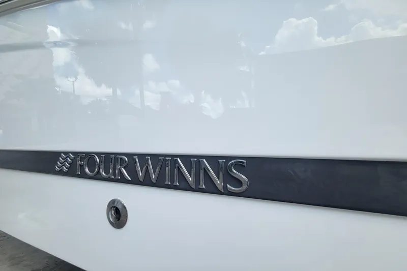 Slide: The Image of 2022 Four Winns HD3 boat logo on white hull. - 4