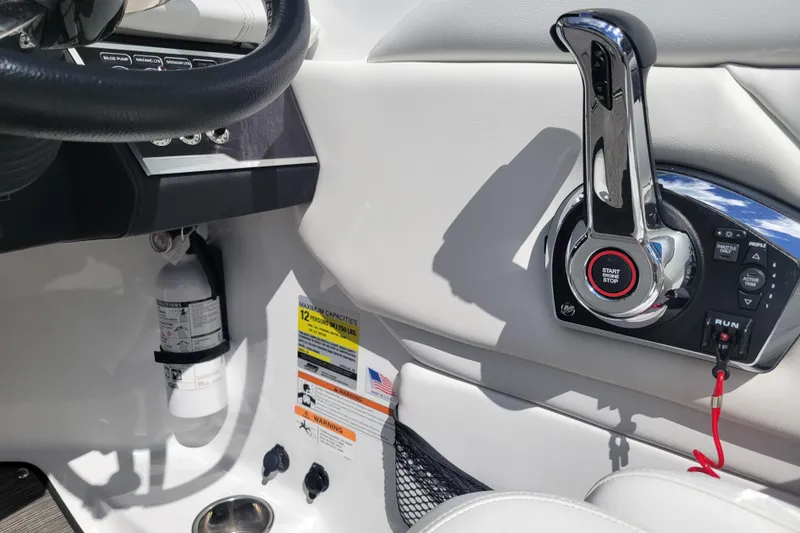 Slide: The Image of 2022 Four Winns HD3 boat cockpit with control panel and fire extinguisher. - 21