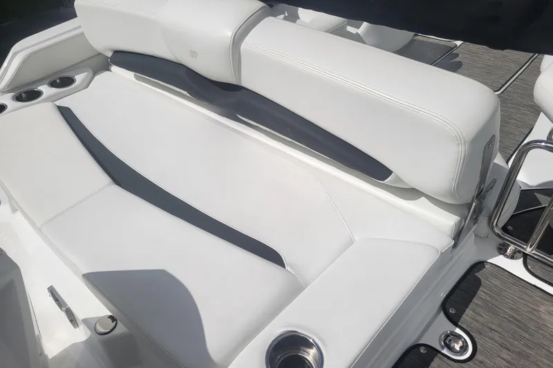 Slide: The Image of 2022 Four Winns HD3 boat interior with white seating and cup holders. - 8
