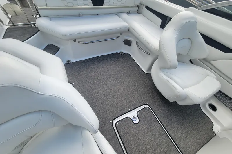 Slide: The Image of 2022 Four Winns HD3 boat interior with white seating and gray flooring. - 17