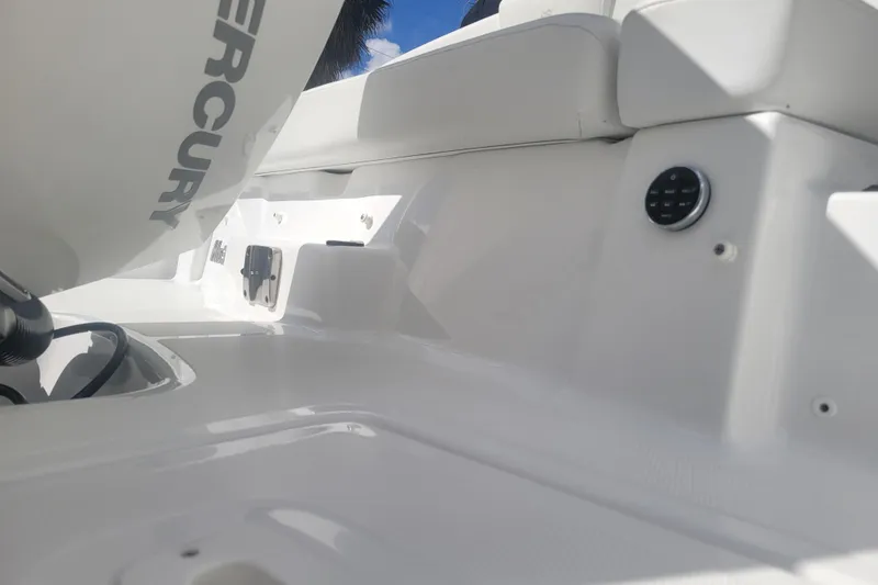 Slide: The Image of 2022 Four Winns HD3 boat interior with Mercury engine, showcasing sleek white design. - 7