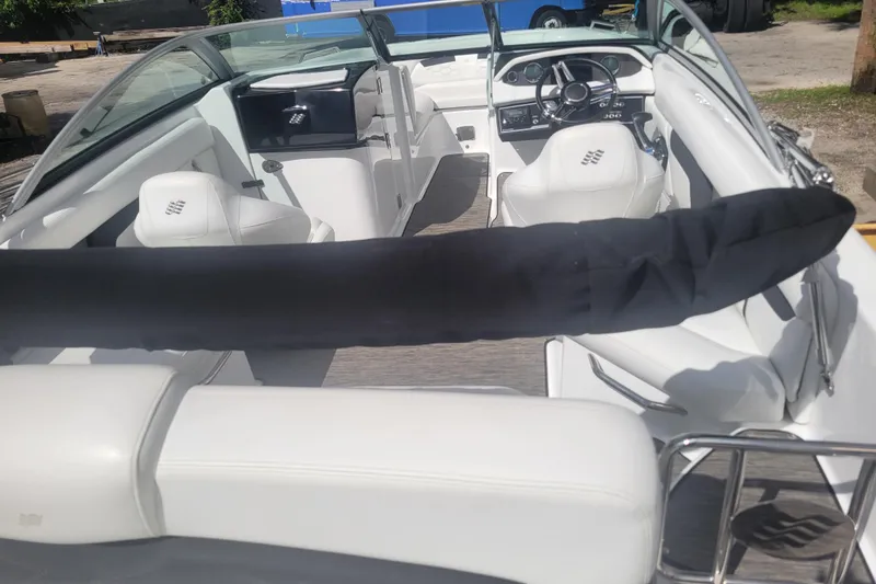 Slide: The Image of 2022 Four Winns HD3 boat interior with white seating and steering wheel. - 10