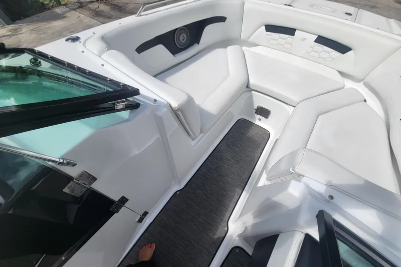 Slide: The Image of 2022 Four Winns HD3 boat interior with white seating and modern design. - 30
