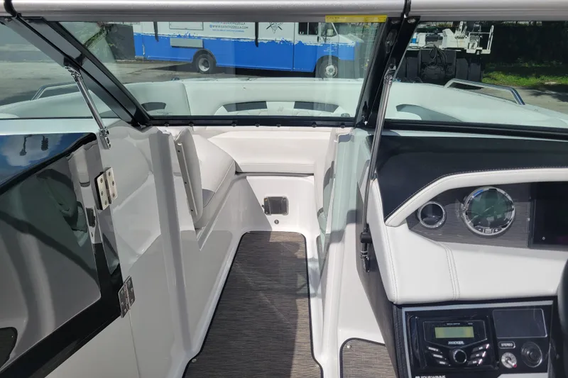 Slide: The Image of Interior view of 2022 Four Winns HD3 boat, featuring sleek dashboard and seating. - 37