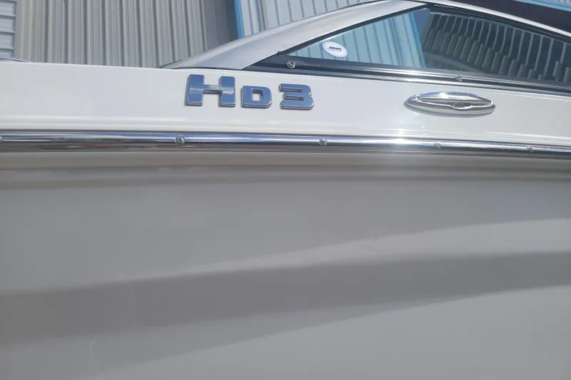 Slide: The Image of 2022 Four Winns HD3 boat side view with chrome detailing. - 3