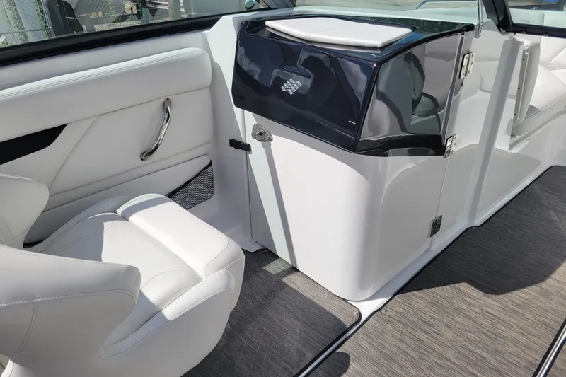 Slide: The Image of 2022 Four Winns HD3 boat interior with white seating and sleek design. - 22