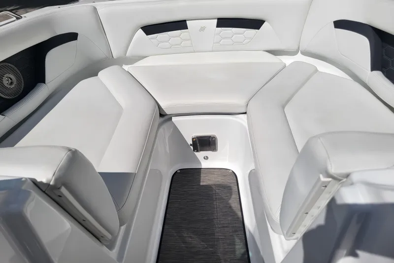 Slide: The Image of 2022 Four Winns HD3 boat interior with white cushioned seating and modern design. - 33