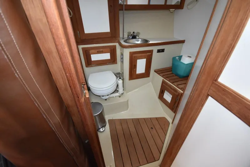 Slide: The Image of Compact bathroom in 1984 Catalina 36 MkII sailboat with wooden accents and marine toilet. - 33