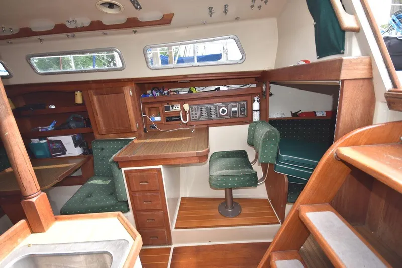 Slide: The Image of Interior of 1984 Catalina 36 MkII sailboat with wooden cabinetry and green upholstered seating. - 24
