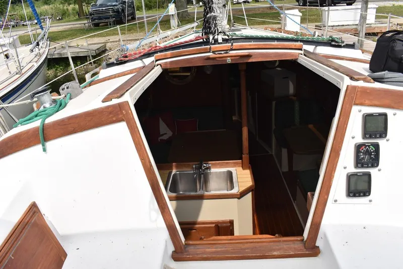 Slide: The Image of Cockpit view of 1984 Catalina 36 MkII sailboat with open cabin and navigation instruments. - 21