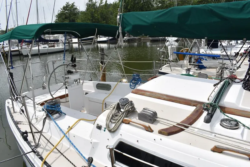 Slide: The Image of 1984 Catalina 36 MkII sailboat docked, featuring green canopy and well-equipped deck. - 6