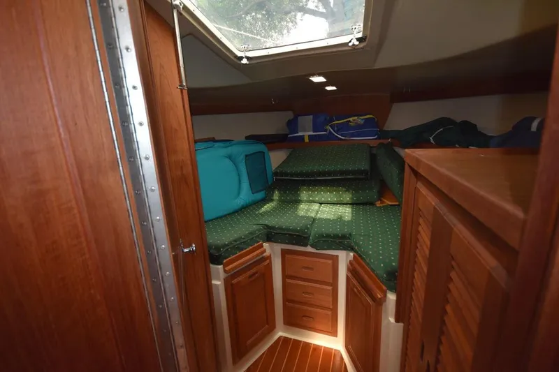 Slide: The Image of Interior cabin of a 1984 Catalina 36 MkII sailboat with wooden cabinetry and green cushions. - 30
