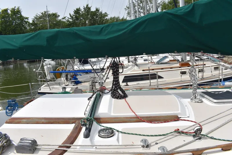 Slide: The Image of 1984 Catalina 36 MkII sailboat docked, featuring green sail cover and deck details. - 8