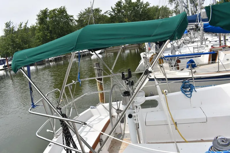 Slide: The Image of Sailboat Catalina 36 MkII, 1984 model, docked with green canopy and marina background. - 14