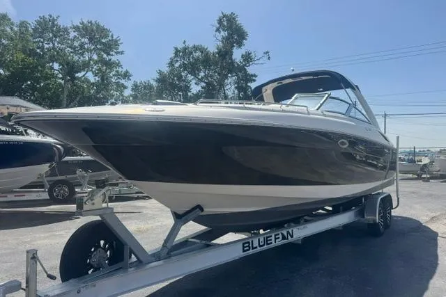Slide: The Image of 2004 Monterey 298SS Super Sport boat on trailer, parked outdoors under clear sky. - 6
