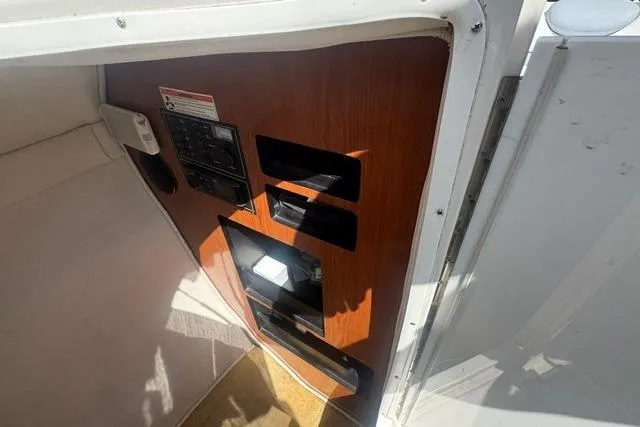Slide: The Image of Interior view of a 2004 Monterey 298SS Super Sport boat with control panel and wood finish. - 18
