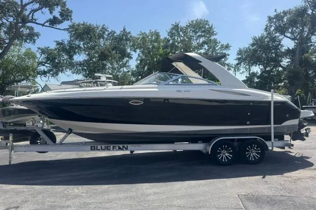 Slide: The Image of 2004 Monterey 298SS Super Sport boat on trailer, parked outdoors under clear sky. - 5