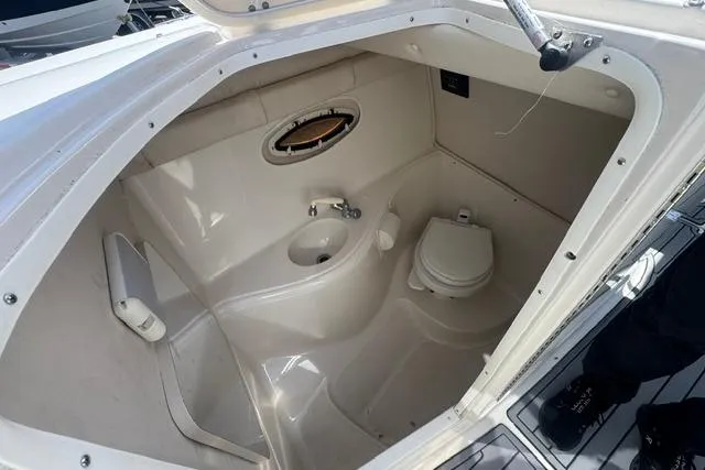 Slide: The Image of Interior of a 2004 Monterey 298SS Super Sport boat bathroom with sink and toilet. - 20