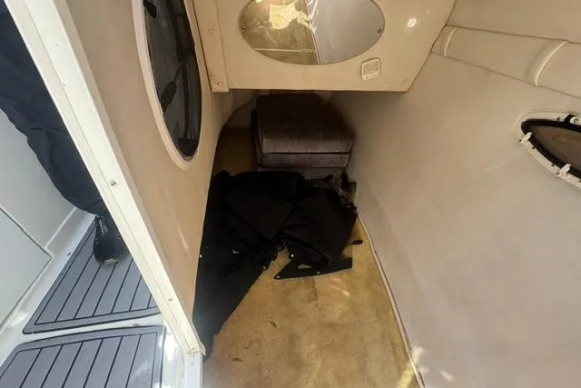 Slide: The Image of Interior cabin of a 2004 Monterey 298SS Super Sport boat, featuring seating and storage. - 19
