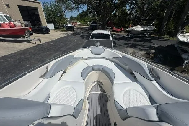 Slide: The Image of 2004 Monterey 298SS Super Sport boat with spacious seating in a marina setting. - 21