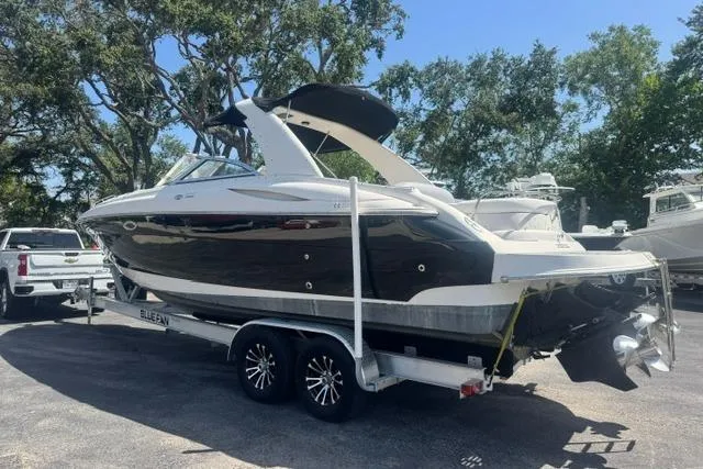 Slide: The Image of 2004 Monterey 298SS Super Sport boat on trailer, parked outdoors. - 4