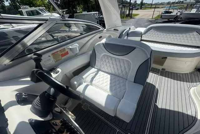 Slide: The Image of Interior of a 2004 Monterey 298SS Super Sport boat with white seating and steering wheel. - 16