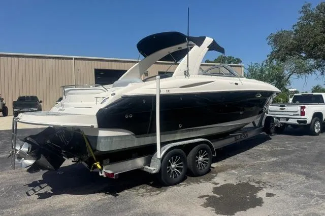 Slide: The Image of 2004 Monterey 298SS Super Sport boat on trailer, parked outdoors near a building. - 2