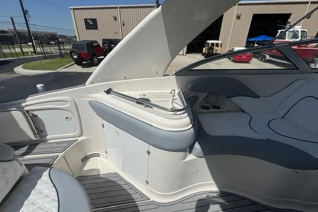 Slide: The Image of Interior of a 2004 Monterey 298SS Super Sport boat with white seating and storage. - 14