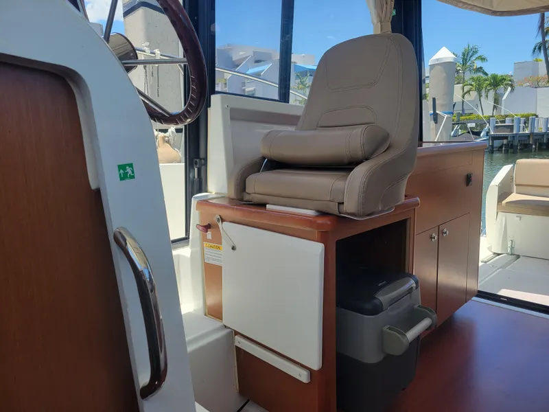 Slide: The Image of Interior of 2016 Jeanneau Merry Fisher 855 boat with helm seat and storage. - 28