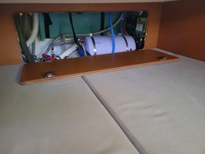 Slide: The Image of Interior view of 2016 Jeanneau Merry Fisher 855, showing storage compartment and plumbing. - 38
