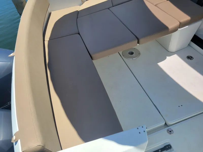 Slide: The Image of Jeanneau Merry Fisher 855, 2016 model, featuring beige seating and deck area. - 12