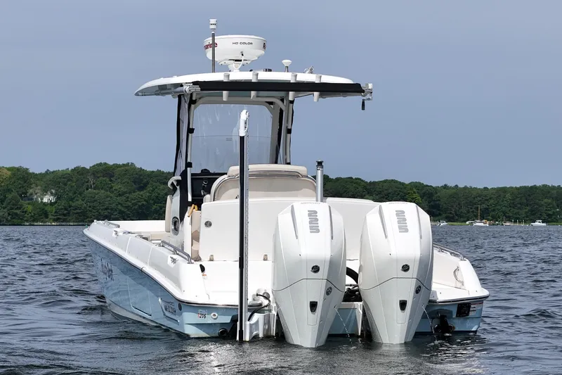 Slide: The Image of 2021 Boston Whaler 270 Dauntless boat with dual engines on a calm lake. - 4