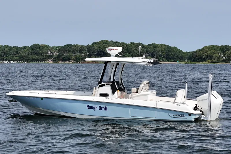 Slide: The Image of 2021 Boston Whaler 270 Dauntless boat on water, labeled "Rough Draft," with scenic background. - 2