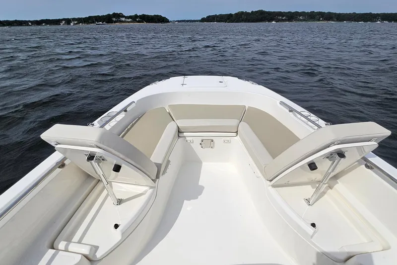 Slide: The Image of 2021 Boston Whaler 270 Dauntless boat interior with cushioned seating on open water. - 12