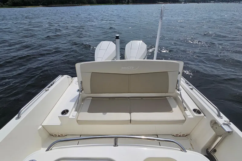 Slide: The Image of 2021 Boston Whaler 270 Dauntless boat with dual engines on a calm lake. - 24
