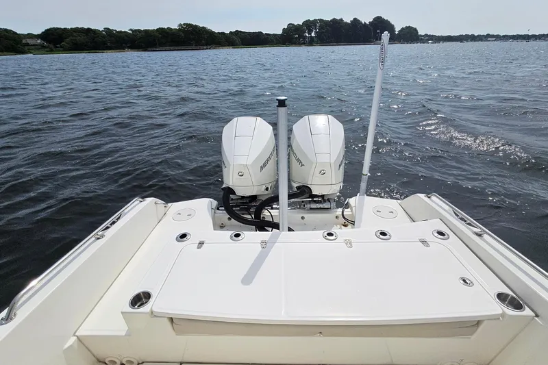 Slide: The Image of 2021 Boston Whaler 270 Dauntless boat with dual Mercury engines on a calm lake. - 25