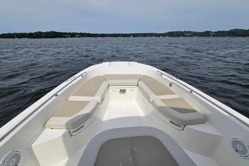 Slide: The Image of 2021 Boston Whaler 270 Dauntless boat on calm water, featuring spacious seating area. - 10
