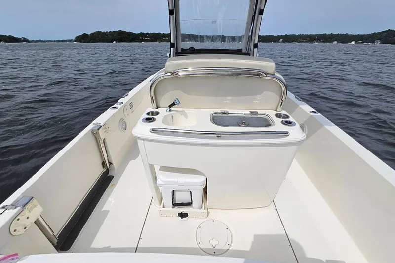 Slide: The Image of 2021 Boston Whaler 270 Dauntless boat interior with sink, on a calm lake. - 22