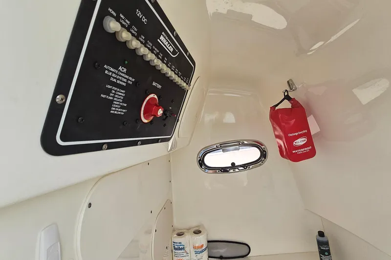 Slide: The Image of Interior view of a 2021 Boston Whaler 270 Dauntless boat with control panel and porthole. - 29