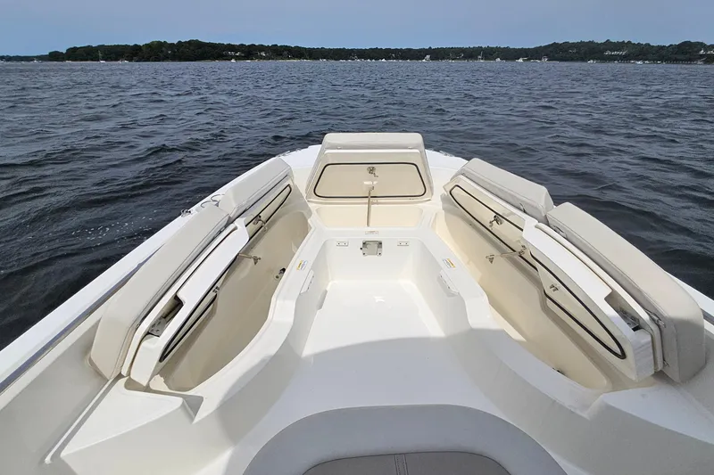Slide: The Image of 2021 Boston Whaler 270 Dauntless boat interior with open seating on calm water. - 11