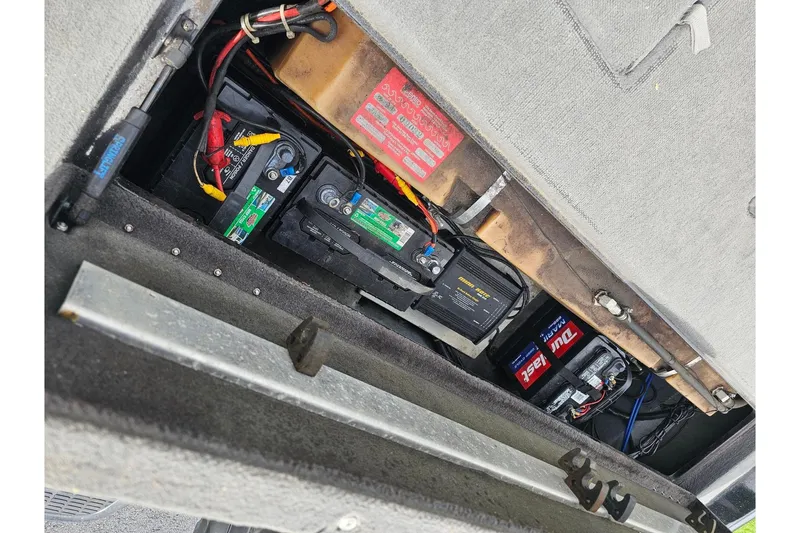 Slide: The Image of Battery compartment of a 1994 Nitro 180 FS boat, showing multiple batteries and wiring. - 12