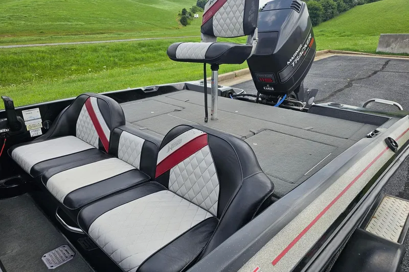 Slide: The Image of 1994 Nitro 180 FS boat interior with cushioned seating and Mercury Tracker 115 outboard motor. - 6